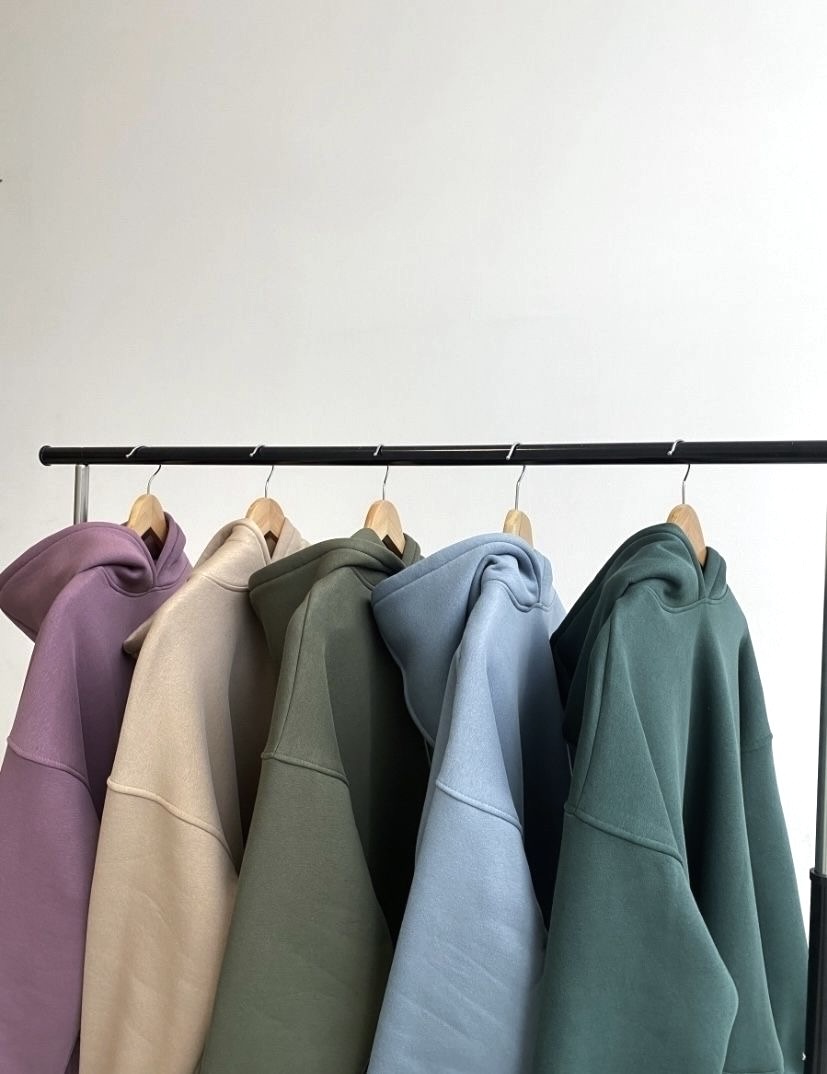 Row of multi‑coloured hoodies on a rack